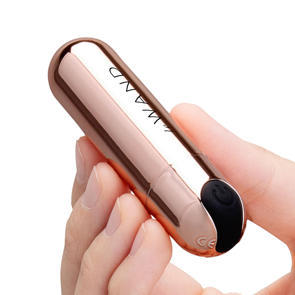 Le Wand Essentials Mini Rose Gold Bullet Vibrator held in hand, showcasing sleek design and practical size.