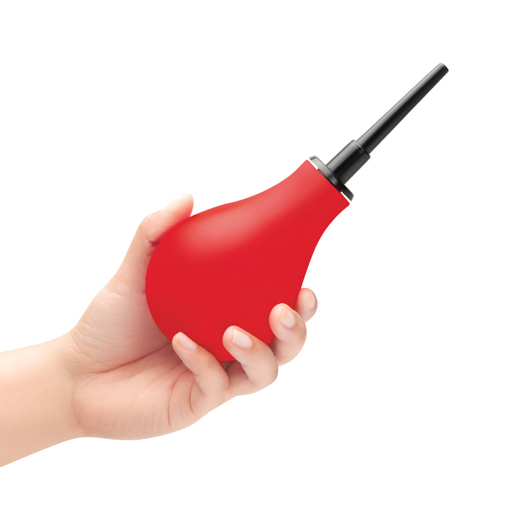 B-Vibe Essentials Hydrobulb Anal Douche 200 ml shown in hand, red squeezable bulb for anal hygiene.
