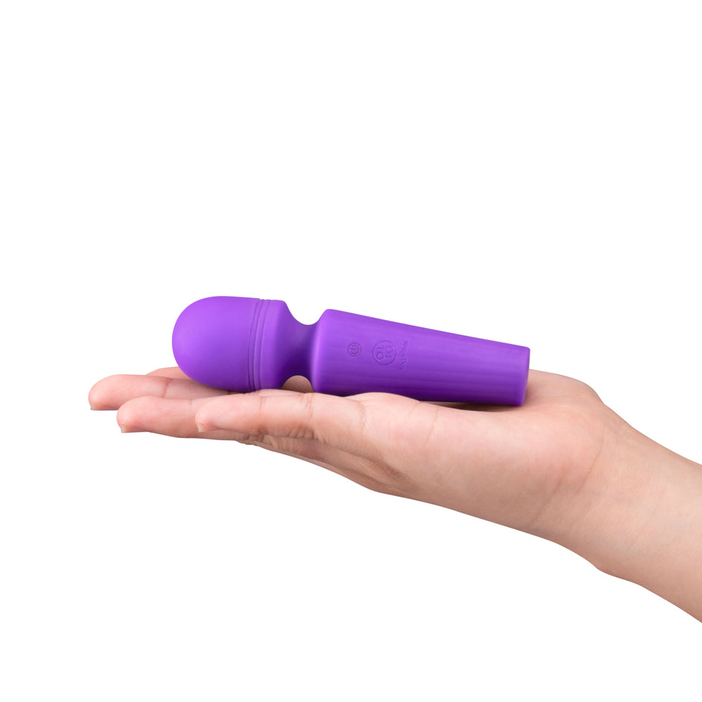 Together Glow On The Go Mini Wand Vibrator Purple held in hand, showcasing its portable design and vibrant color.