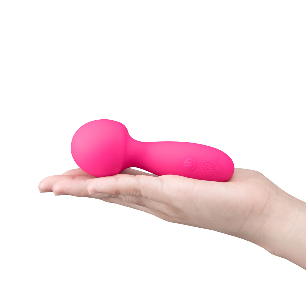 Together Spark On The Go Mini Wand Vibrator held in hand, showcasing its compact design and vibrant color.