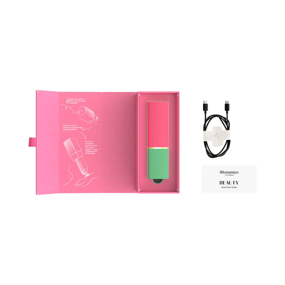 Womanizer Beauty Clitoral Stimulator Green Pink in packaging with guide and charger, designed for discreet pleasure.