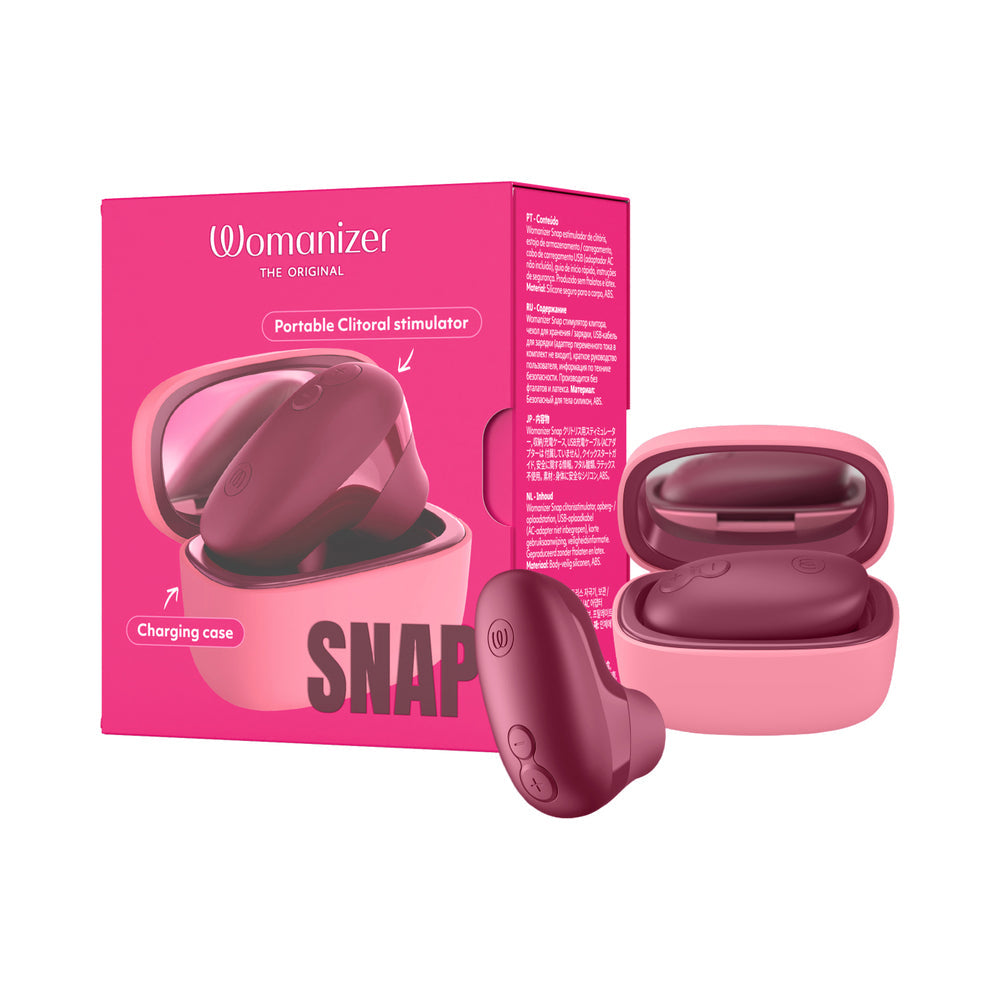 Womanizer Snap Clitoral Stimulator Crushed Berry with charging case and mirror in berry shade.