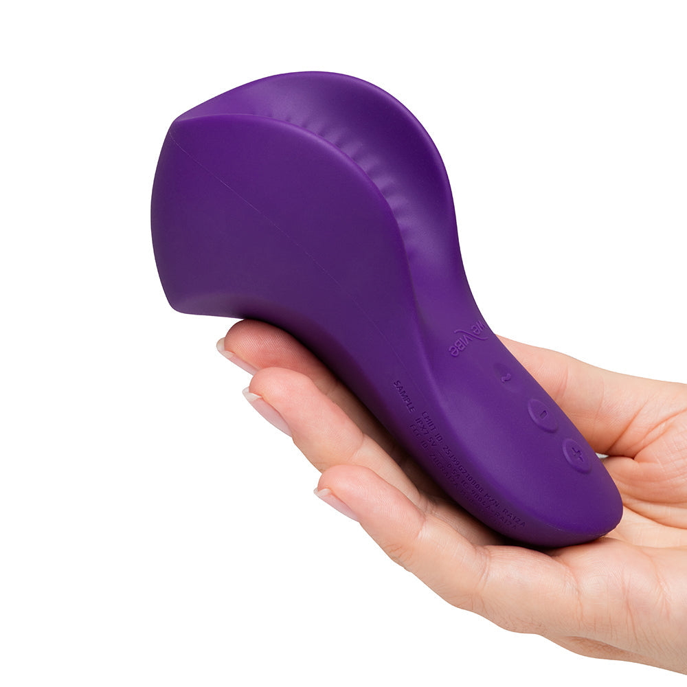We-Vibe Shared Touch Couples Grinding Vibrator Purple in hand showcasing its sleek design and ergonomic shape