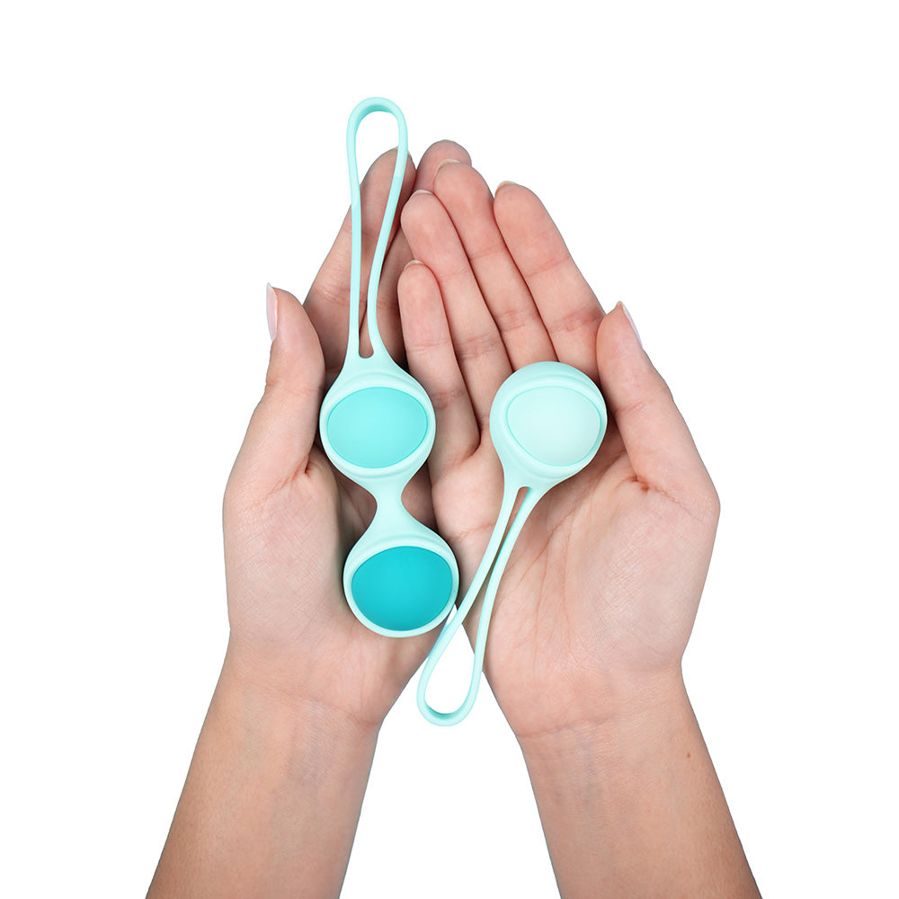 UVA Kegel Balls Set With 3 Progressive Weights held in hands, showcasing smooth silicone design for pelvic floor training.