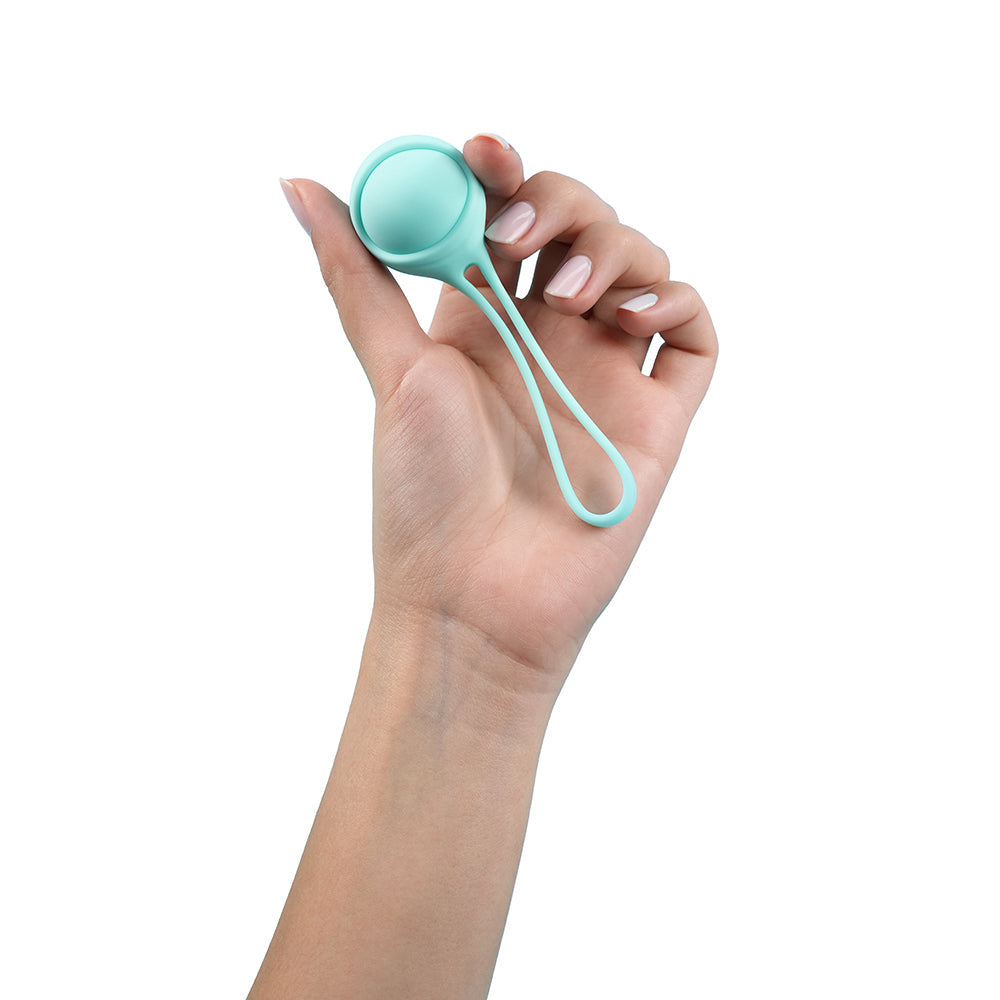 UVA Kegel Balls Set With 3 Progressive Weights held in a hand, showcasing its ergonomic design and body-safe silicone.
