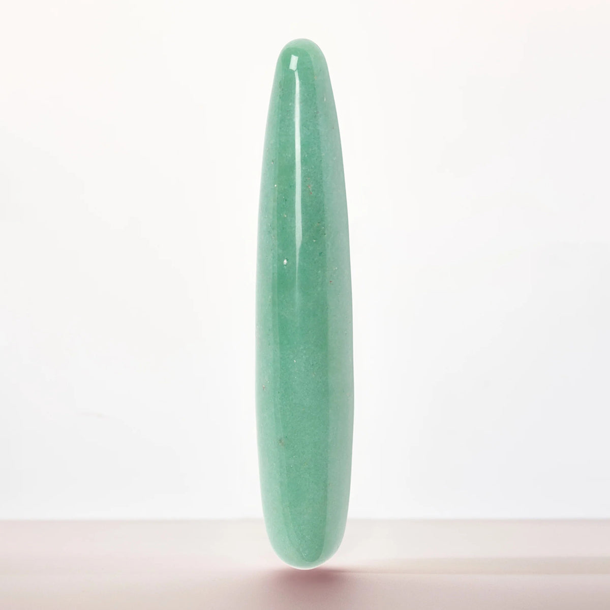 Chakrubs Indian Jade Slim Stone Dildo with a smooth green surface ideal for sensual and self-care experiences.
