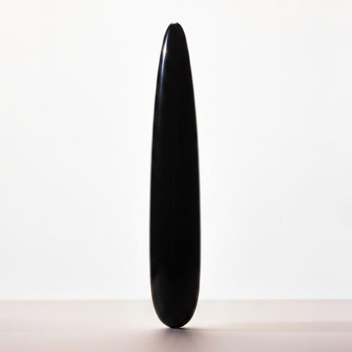 Chakrubs Xaga Slim Non-Phallic Dildo displayed against a minimalist background, emphasizing its sleek design.