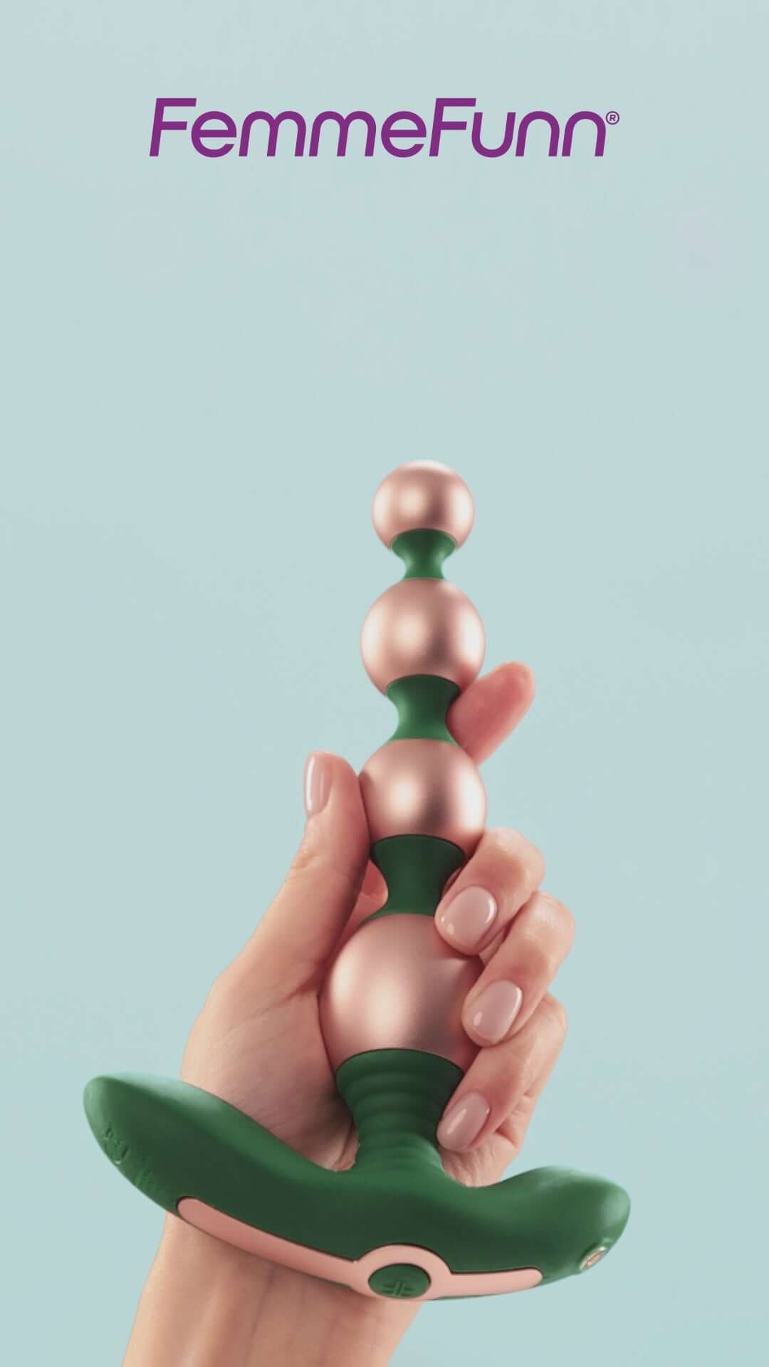 FemmeFunn Bougie Beads Rose Gold in hand against a light blue background showcasing elegant design.