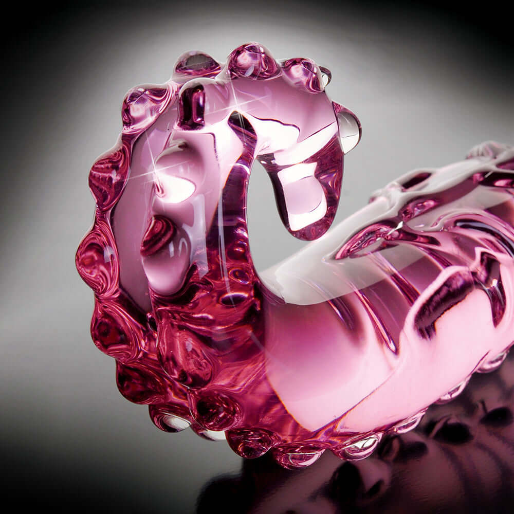 Icicles Number 24 Curved Glass Dildo Pink 6 inches on a reflective surface showcasing its elegant design.