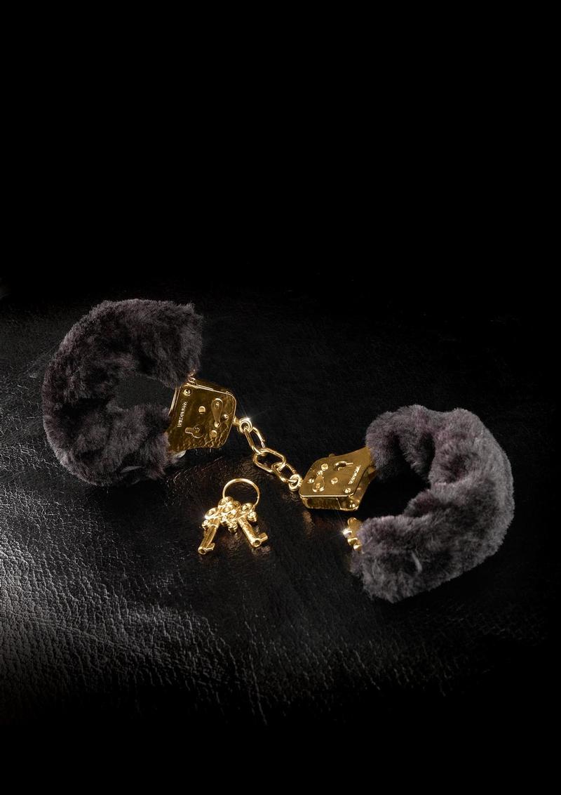 Fetish Fantasy Gold Deluxe Furry Cuffs featuring gold metal and plush faux fur on a dark background.