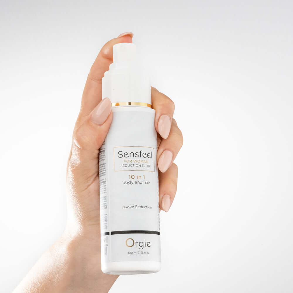 Orgie Sensfeel For Woman Seduction Elixir 10-in-1 Body & Hair held in a hand against a white background.