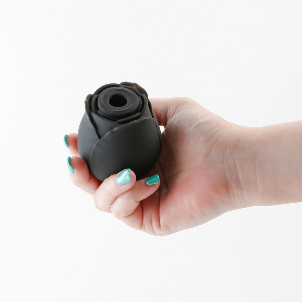 INYA The Rose Black Air Suction Clitoral Vibrator held in a hand, showcasing its rose design and sleek black finish.