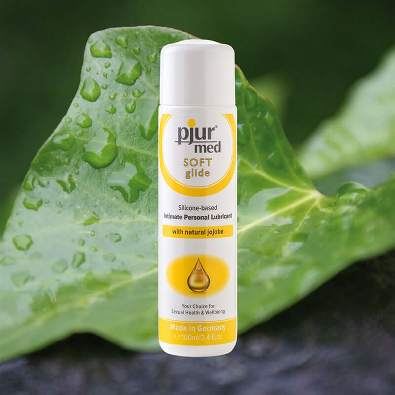Pjur Med Soft Glide Silicone-Based Lubricant 3.4 Oz on a leaf background, featuring a moisturizing formula.