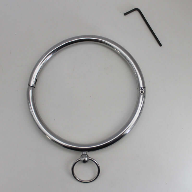 Rouge Stainless Steel Collar displayed with an Allen wrench, showcasing its sleek design and shiny finish.