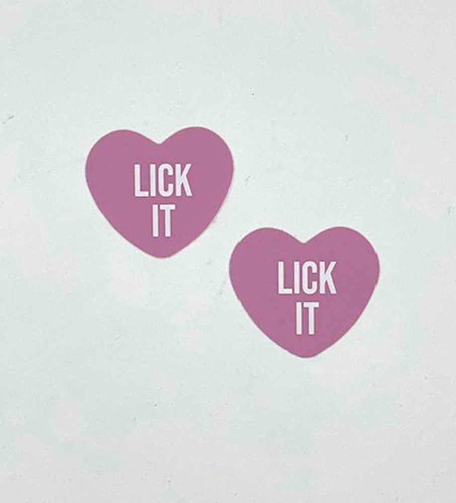 Neva Nude Lick It Light Pink Candy Heart Pasties in heart shape with text "LICK IT" for playful lingerie styling.