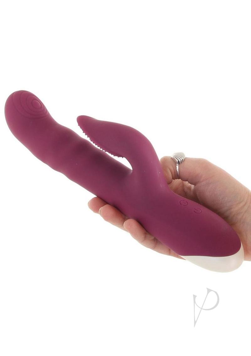 Lovely Lucy Silicone Dual Vibrator Clitoral Stimulator Red held in hand showcasing its sleek design.