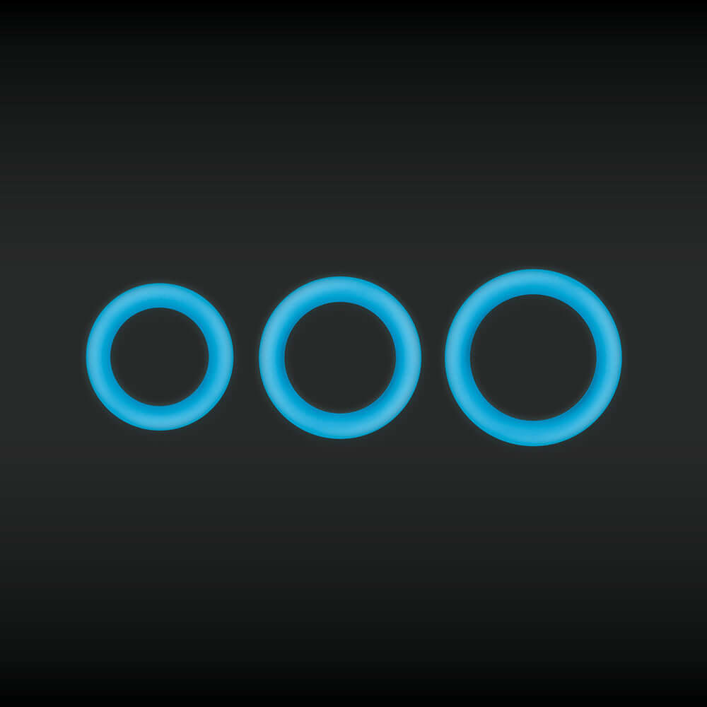 Firefly Halo Medium Silicone Cock Ring Glow In The Dark Blue set of three sizes on a dark background