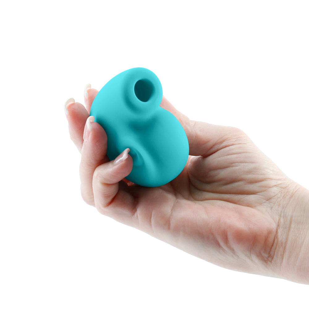 Hand holding the Revel Starlet Snail Air Suction Massager Teal, highlighting its compact and stylish design.
