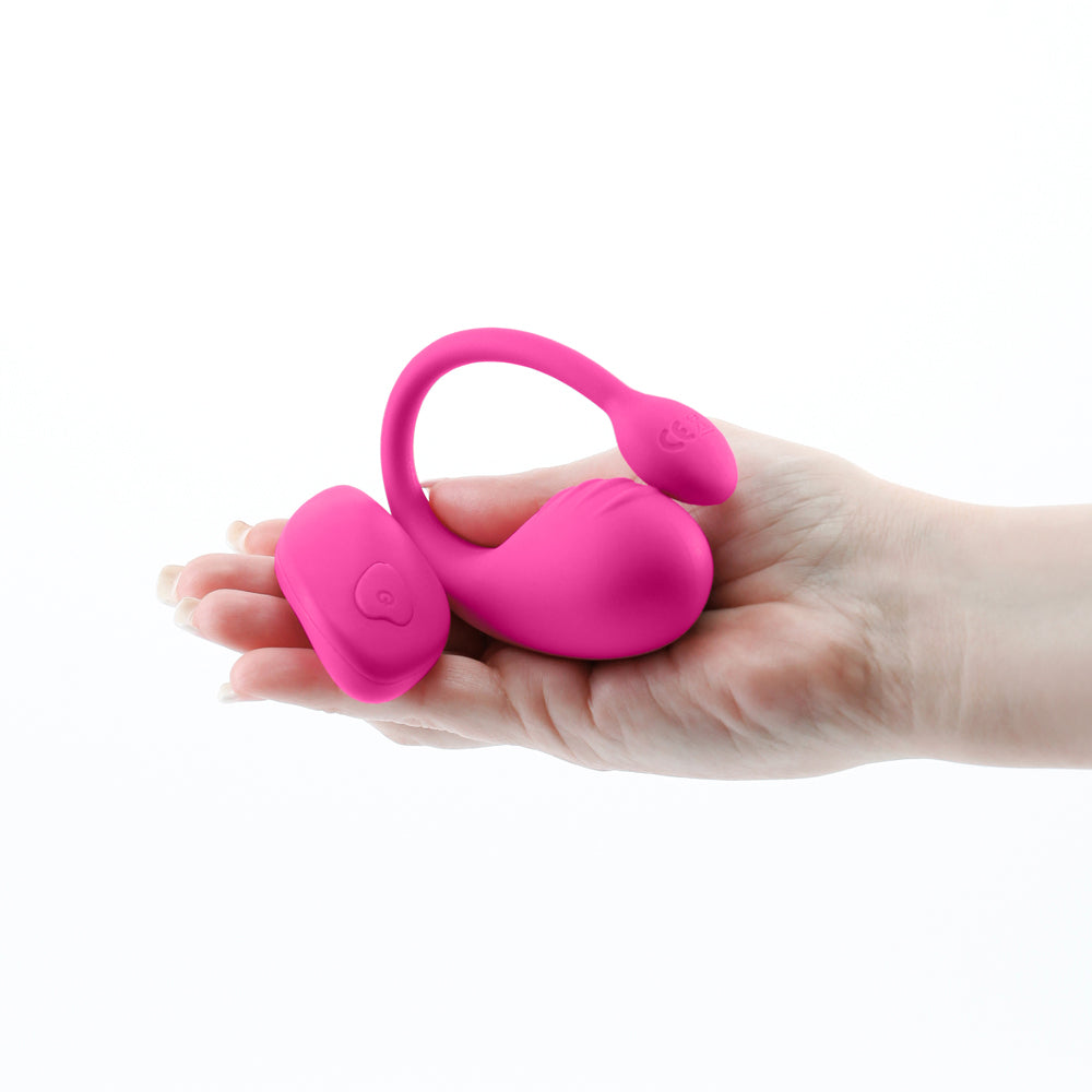 Inya Venus Vibrating Egg with Remote Control Pink, sleek rechargeable silicone vibrator in hand.
