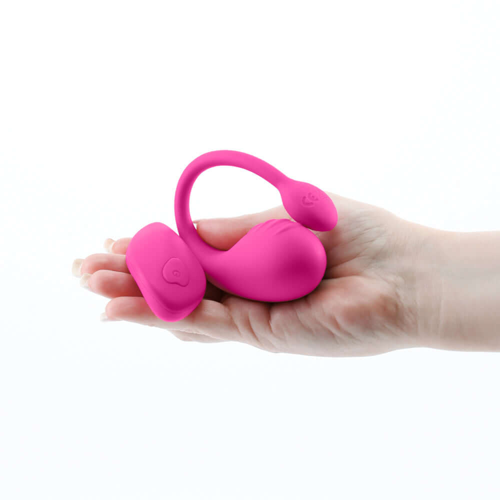Inya Venus Vibrating Egg with Remote Control Pink, sleek rechargeable silicone vibrator in hand.