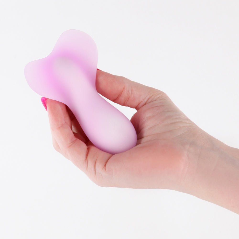 Person holding the Pure Eden Purple Rechargeable Silicone Vibrator in a soft, dreamy purple hue.