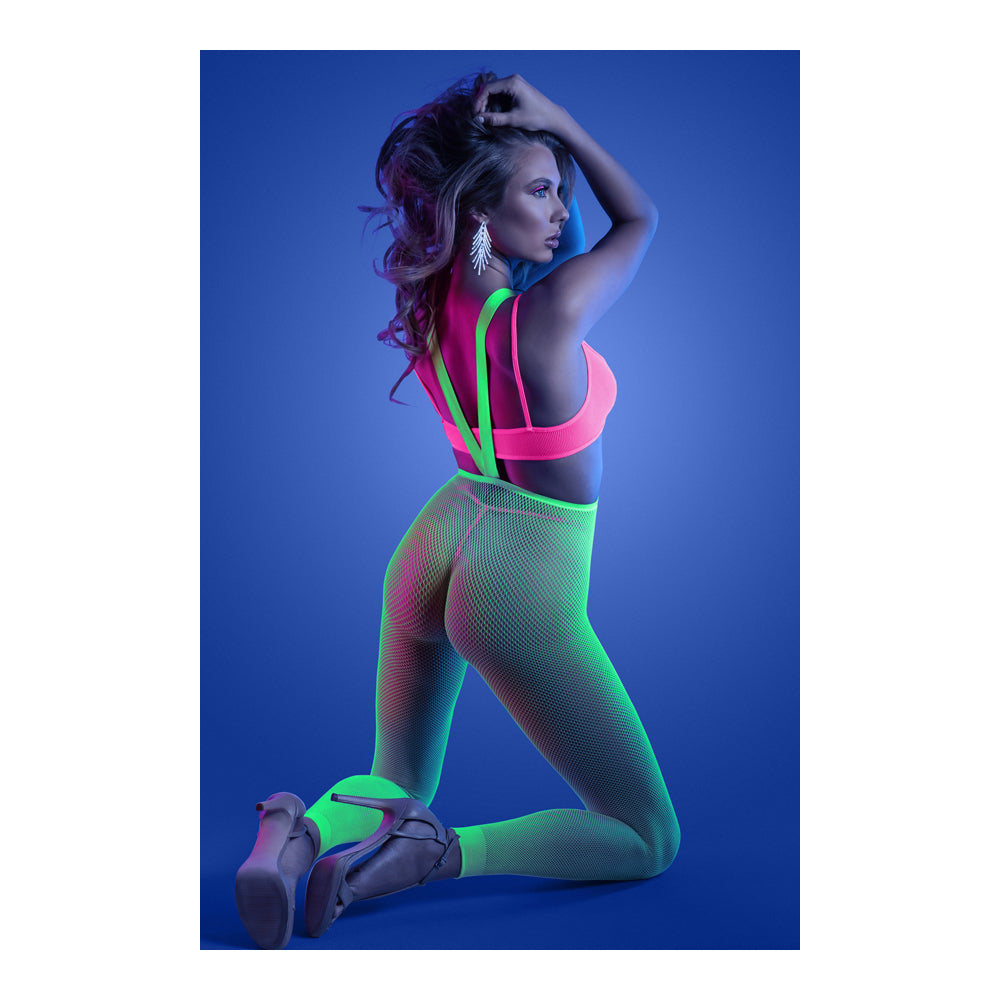 Glow Come Alive 3 Piece Suspender Stockings Set worn in a vibrant pose under blacklight, showcasing neon colors.
