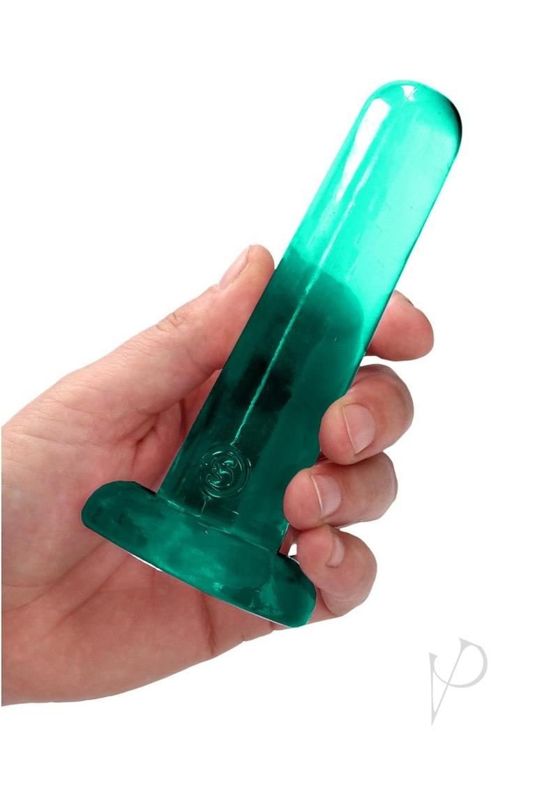 RealRock Crystal Clear Dildo with Suction Cup 5.3 inch held in hand, showcasing its transparent design.