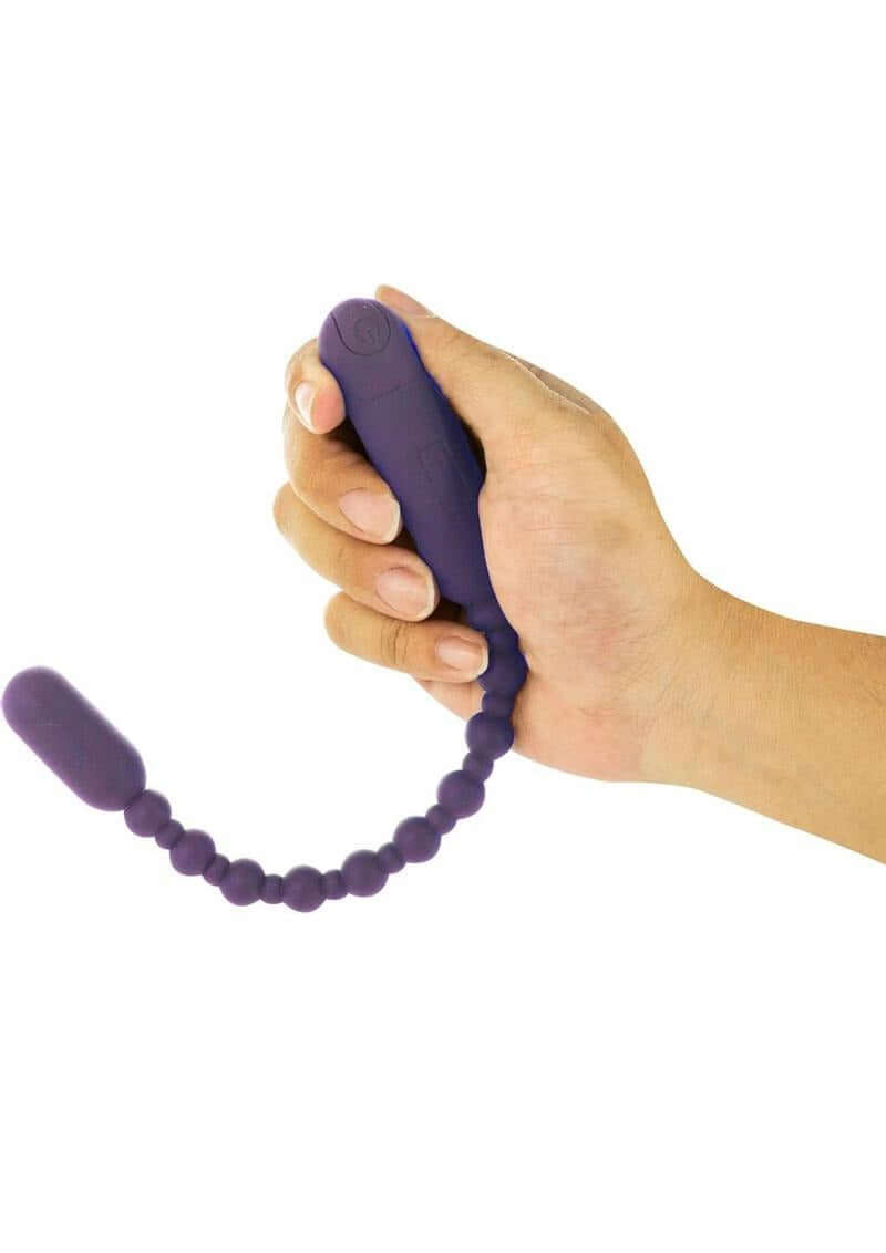 PowerBullet Rechargeable Booty Beads 10 inch Purple held in hand, featuring flexible design and vibrating function.