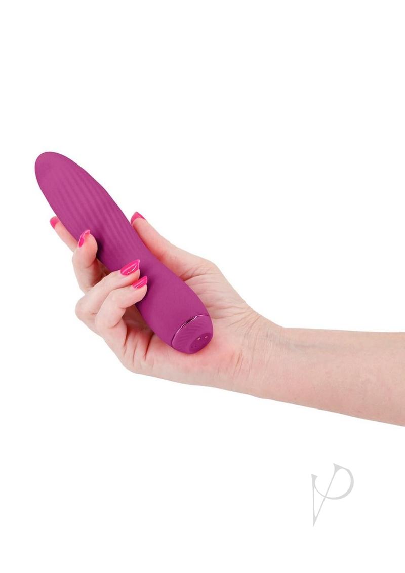 Obsessions Clyde Rechargeable Silicone Vibrator Magenta held in hand, showcasing its flexible design and vibrant color.