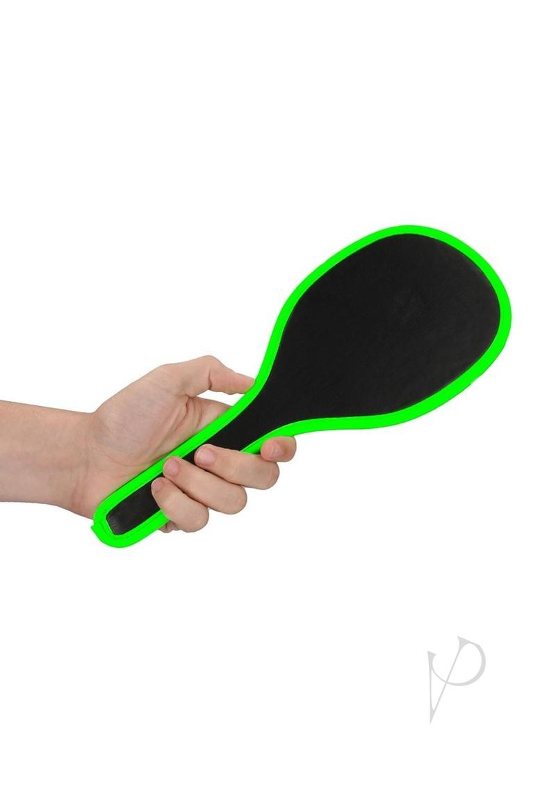 Ouch Round Paddle Glow in the Dark Green held in hand with vibrant fluorescent edge for impact play.