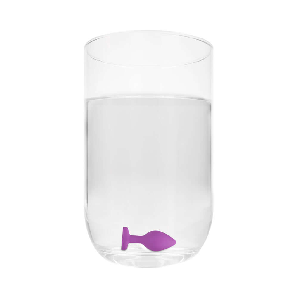 Flexible Silicone Diamond Heart Butt Plug Purple Regular in a glass of water.