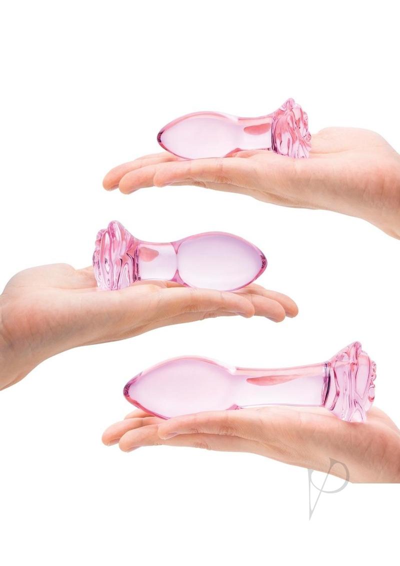 Glas Rosebud Butt Plug Set 3 Piece Pink displayed in open hands showing three graduated sizes.
