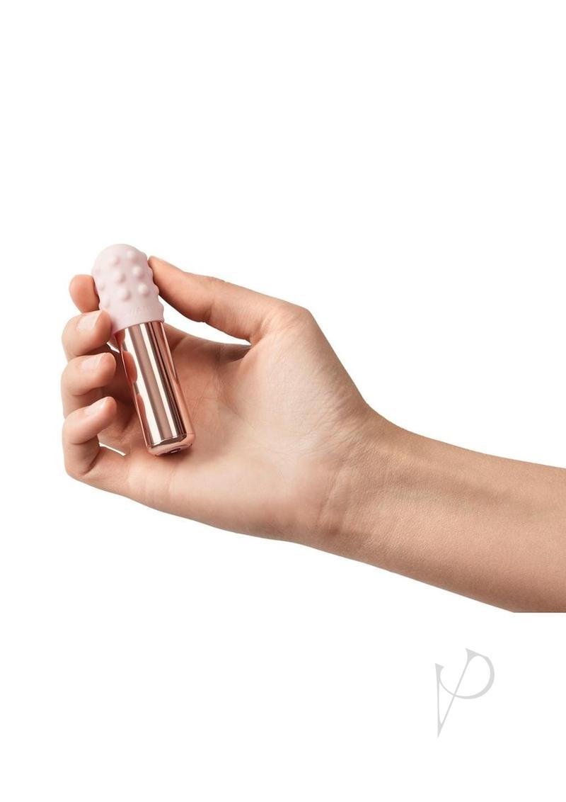 Le Wand Bullet Silicone Sleeve Vibrator Rose Gold held in hand, showcasing its compact and elegant design.