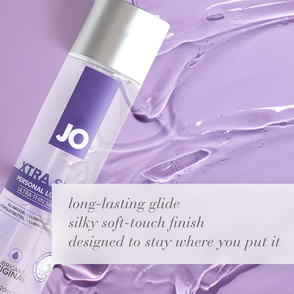 JO Xtra Silky Silicone Lubricant 4 Oz bottle on silky lavender background with moisturizing benefits.