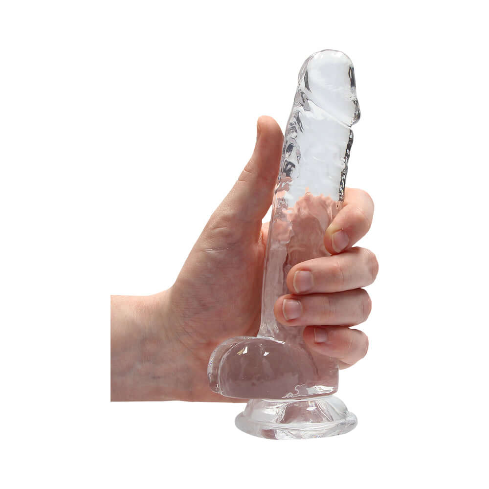 RealRock Crystal Realistic 7 inch Dildo Clear held in hand, showcasing its transparent design and realistic features.