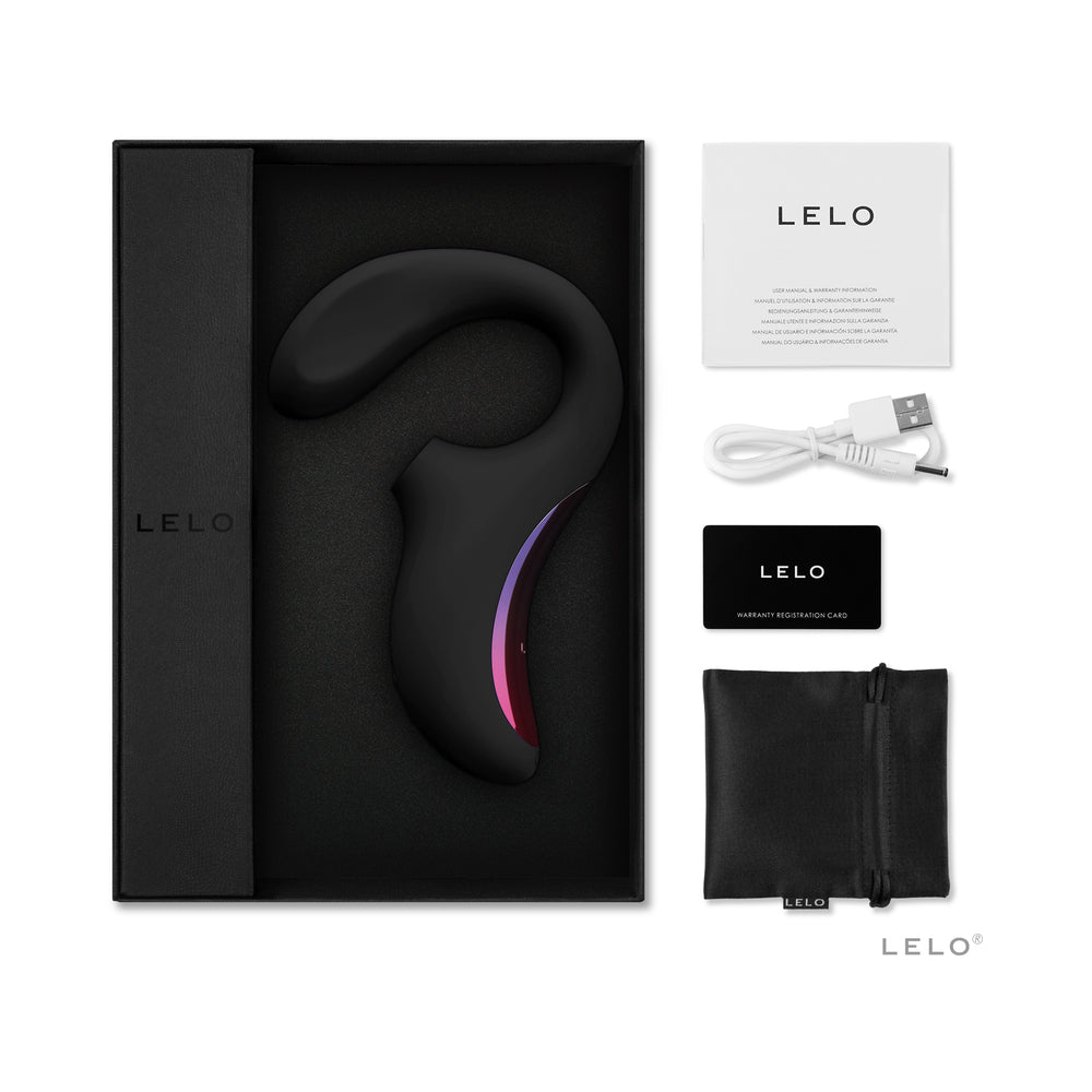 LELO ENIGMA Suction Dual Stimulator Black in its packaging with accessories including a USB cable and warranty card.