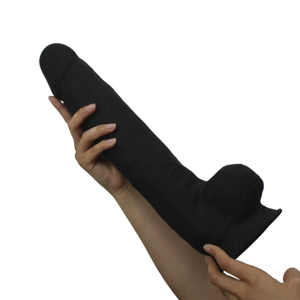 Silex-d The Original Model 1 Dildo 15 inches Black held in a hand, showcasing its length and dual-density silicone design.