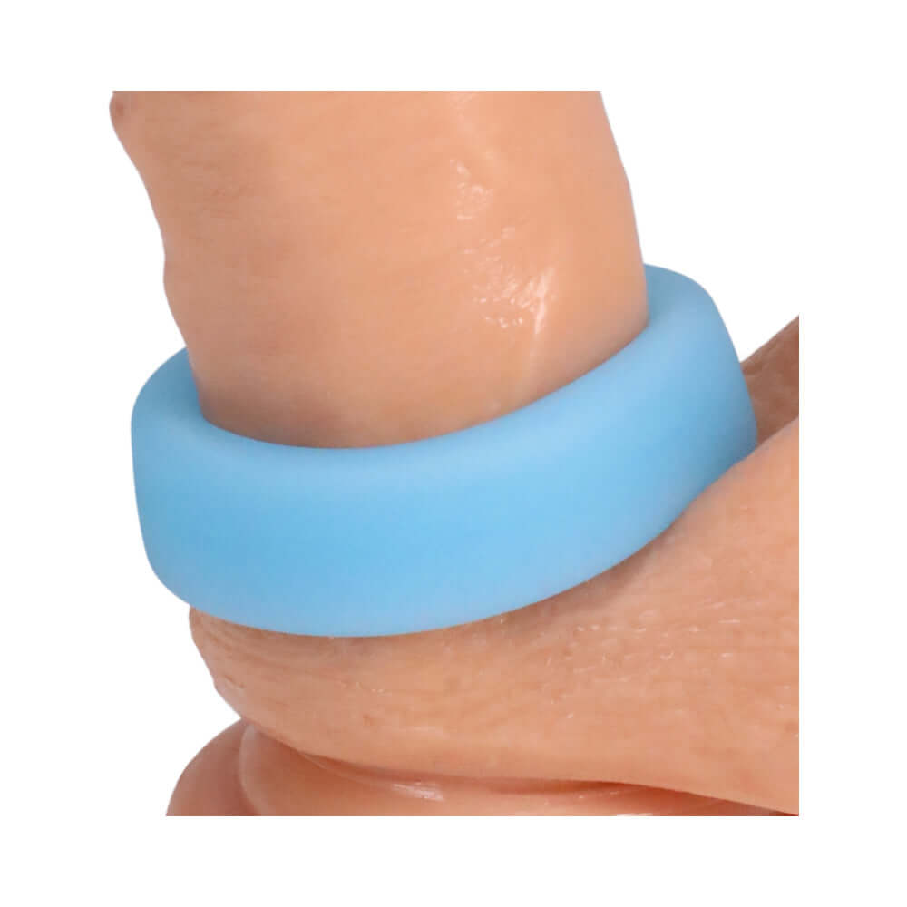 Rock Solid Sila-Flex Glow-in-the-Dark Big O C-Ring Blue on a finger showing its smooth, comfortable design.