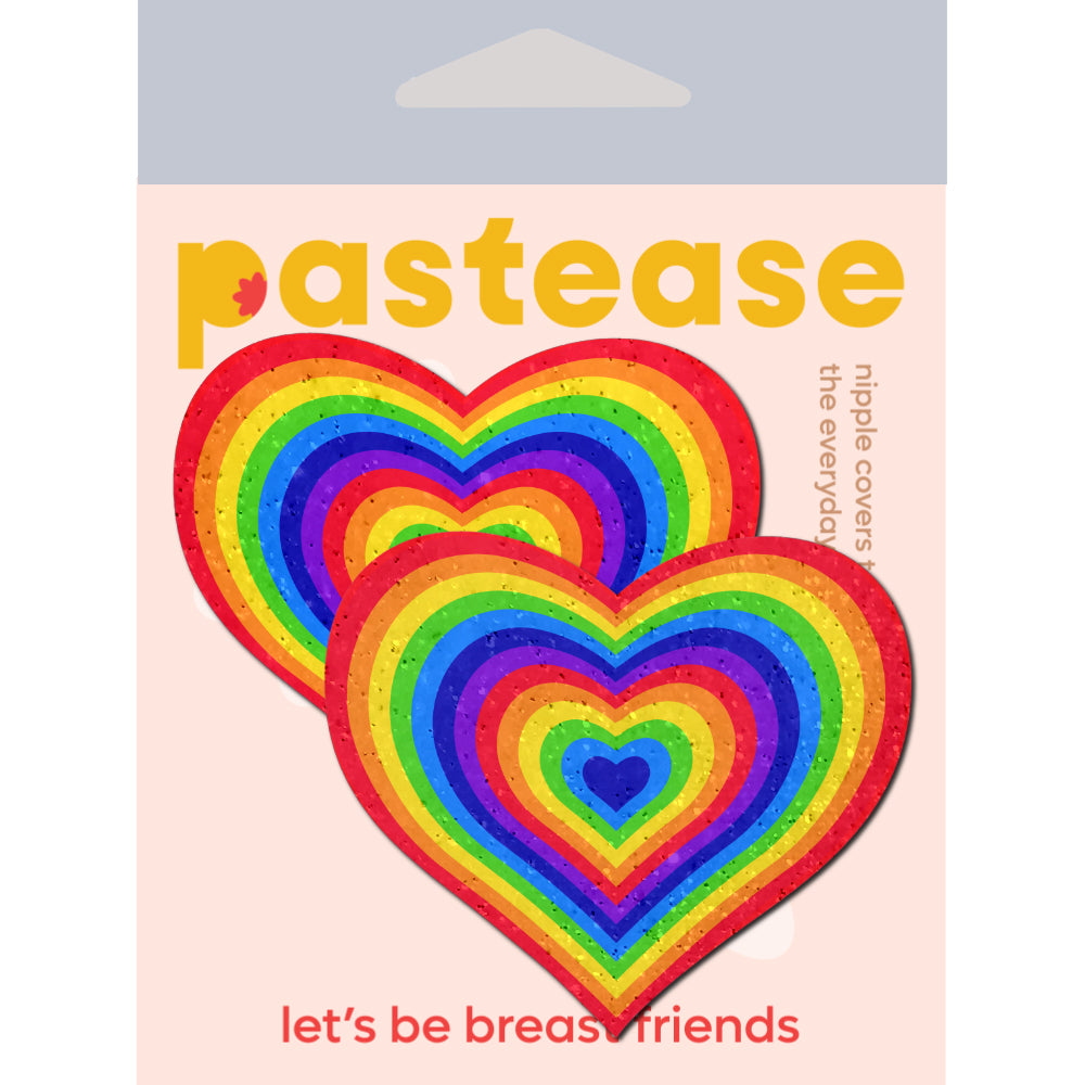 Pastease Love Velvet Rainbow Pumping Heart Nipple Pasties in vibrant colors on packaging background.
