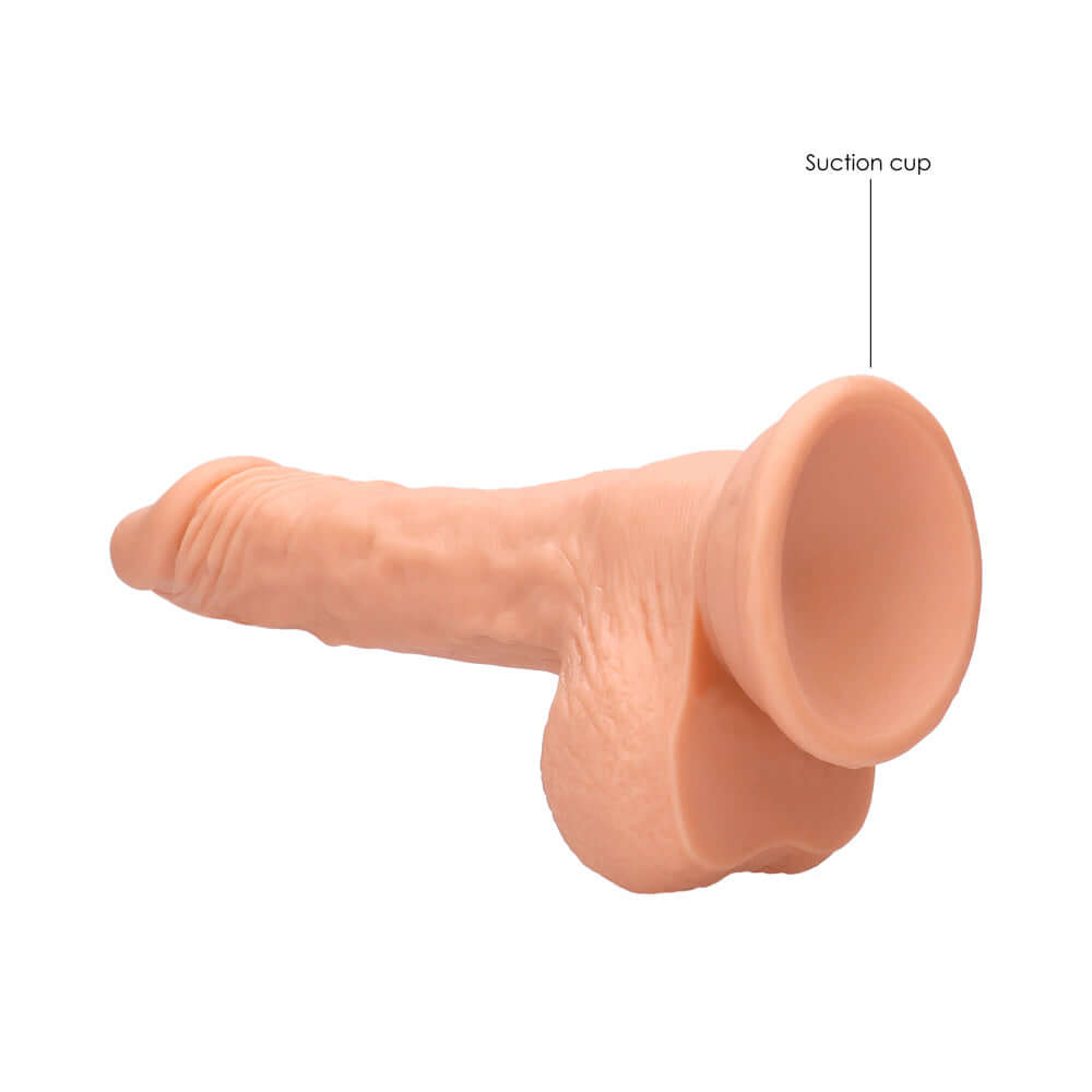 RealRock Realistic 7 inch Dildo With Balls & Suction Cup Beige shown from side, highlighting detailed design and suction cup feature.