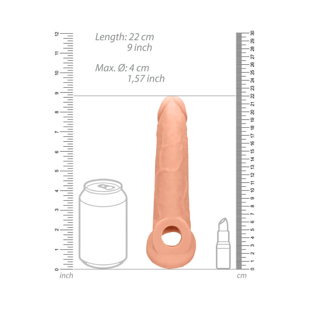 RealRock Realistic 9 inch Penis Sleeve Extender Sling Beige displayed with measuring scale and other objects for size comparison.