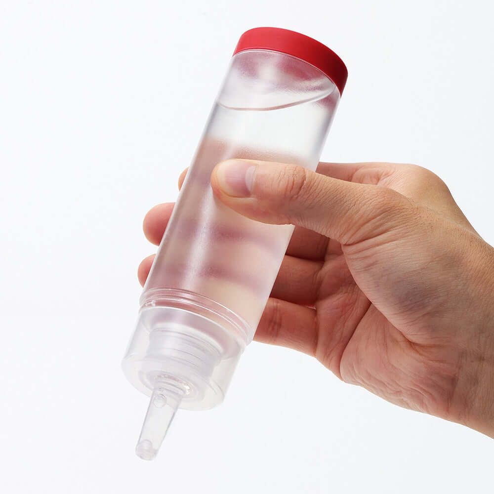 Hand holding Tenga Lotion Regular 5.75 Oz Bottle showcasing its sleek design and easy-to-use nozzle.