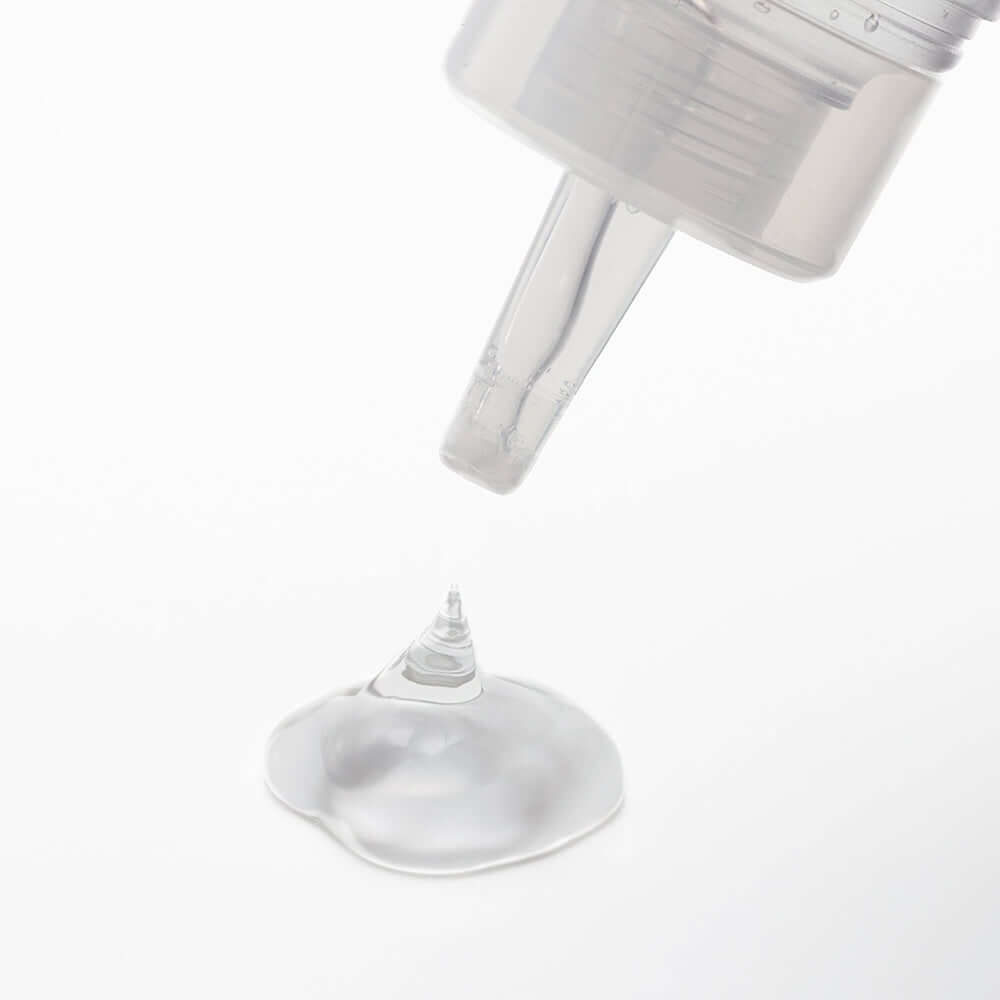 Tenga Lotion Regular 5.75 Oz Bottle with lotion dripping from nozzle onto a smooth surface.