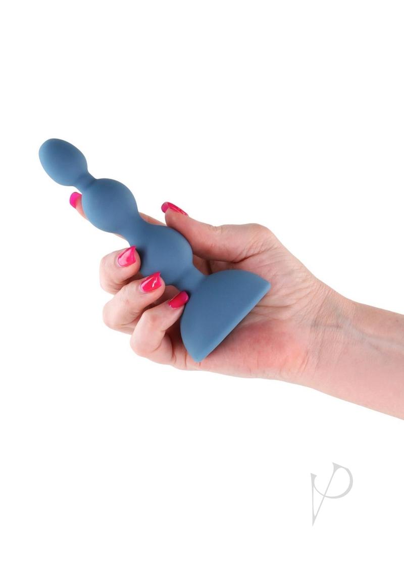Secrets Kai Rechargeable Silicone Anal Plug Teal held in hand, showcasing its smooth design and graduated vibrating beads.