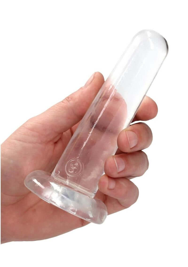 RealRock Crystal Clear Non Realistic Dildo with Suction Cup 5.3 inch in hand for display.