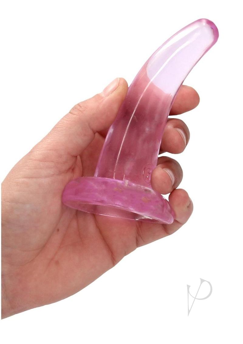 RealRock Crystal Clear 4.7 Inch Suction Cup Dildo Pink held in hand, showcasing its translucent design.
