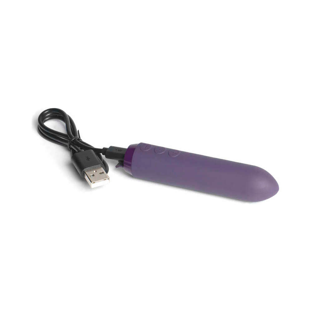 Je Joue Classic Bullet Purple vibrator with USB charging cable on a white background.