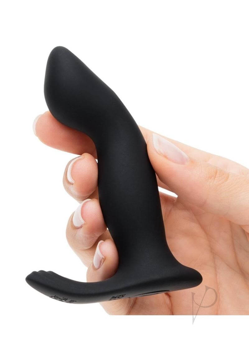 Fifty Shades of Grey Sensation P-Spot Vibrator Black being held in hand, showcasing its sleek design and soft silicone material.