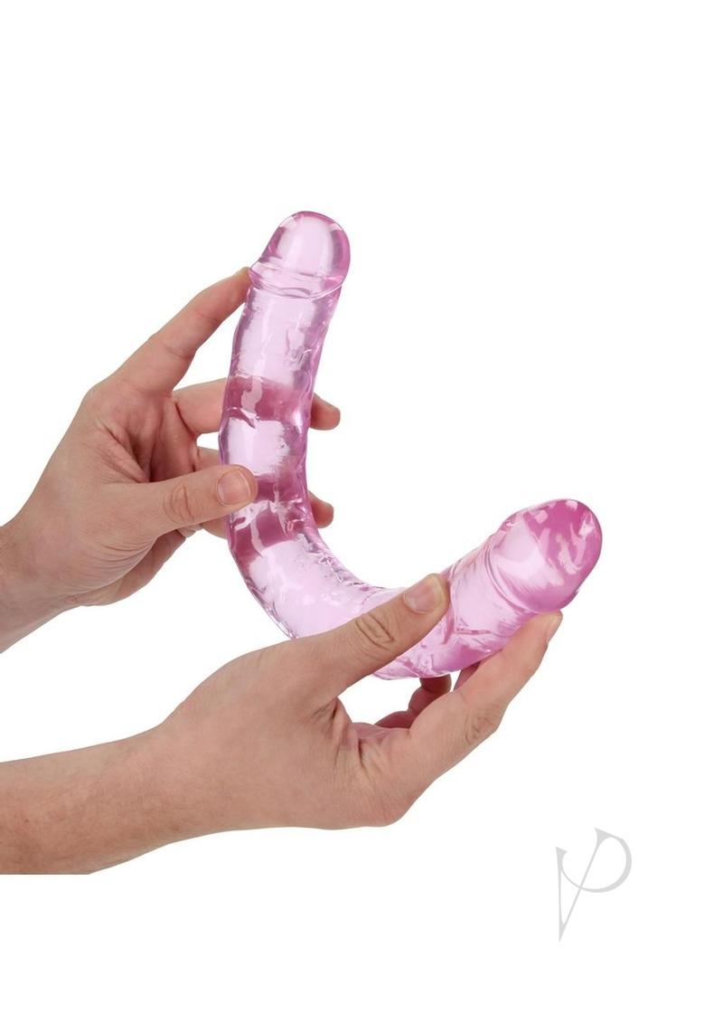 RealRock Crystal Clear Double Dong 13 Inch Pink held in hands, showcasing its see-through design and dual ends.