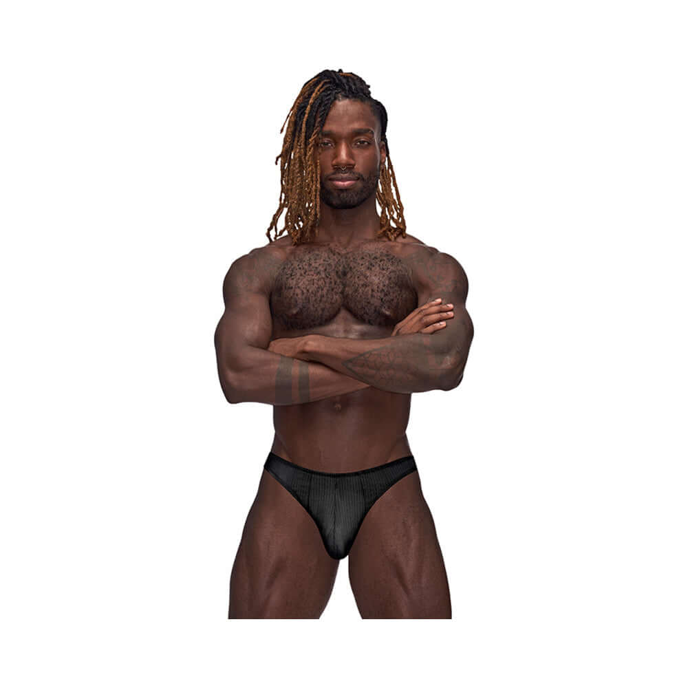 A man modeling the Male Power Barely There Moonshine Black S M jock brief, showcasing a confident and bold look.